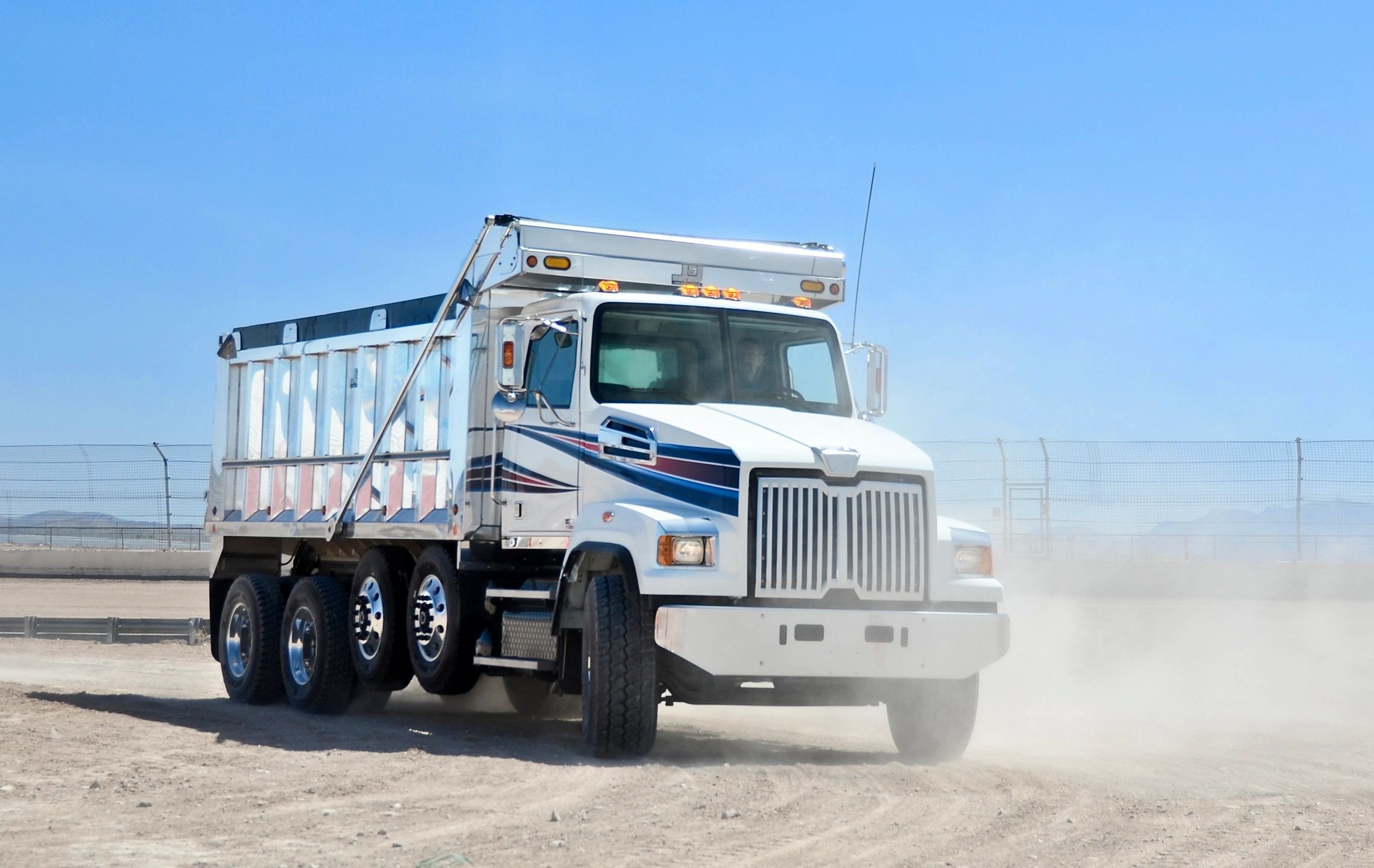 Heavy-duty dump truck on unpaved surface